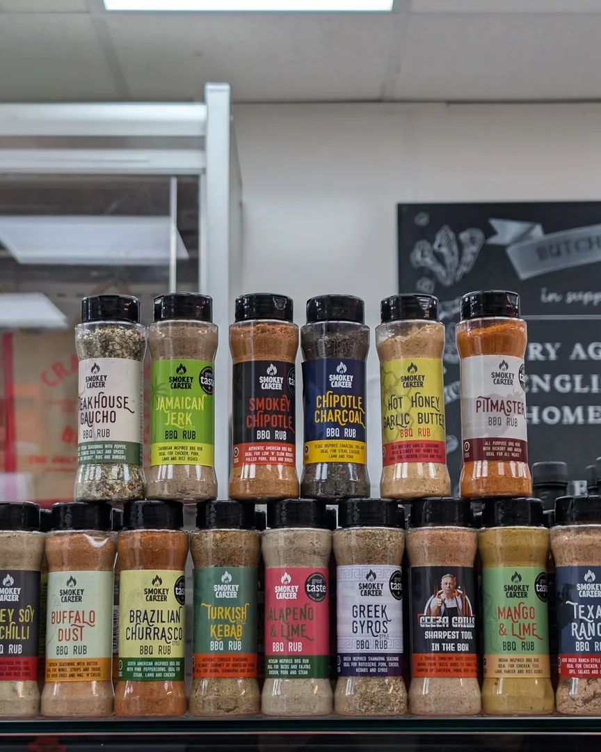 Rows of barbecue rubs and sauces on a shelf in the shop